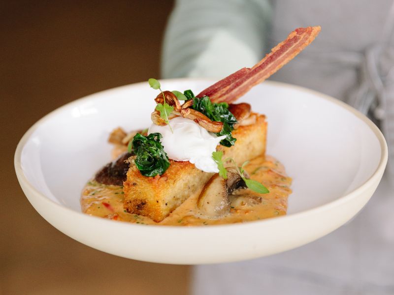 Waitress holding plate with new gourmet hash brown dish