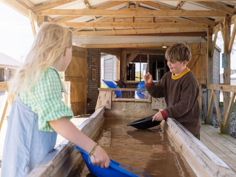 Two young children panning for gold at Cornwall Gold